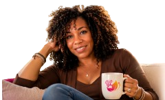 Yevtte Lacy seated with a Yevtte Lacy Books mug